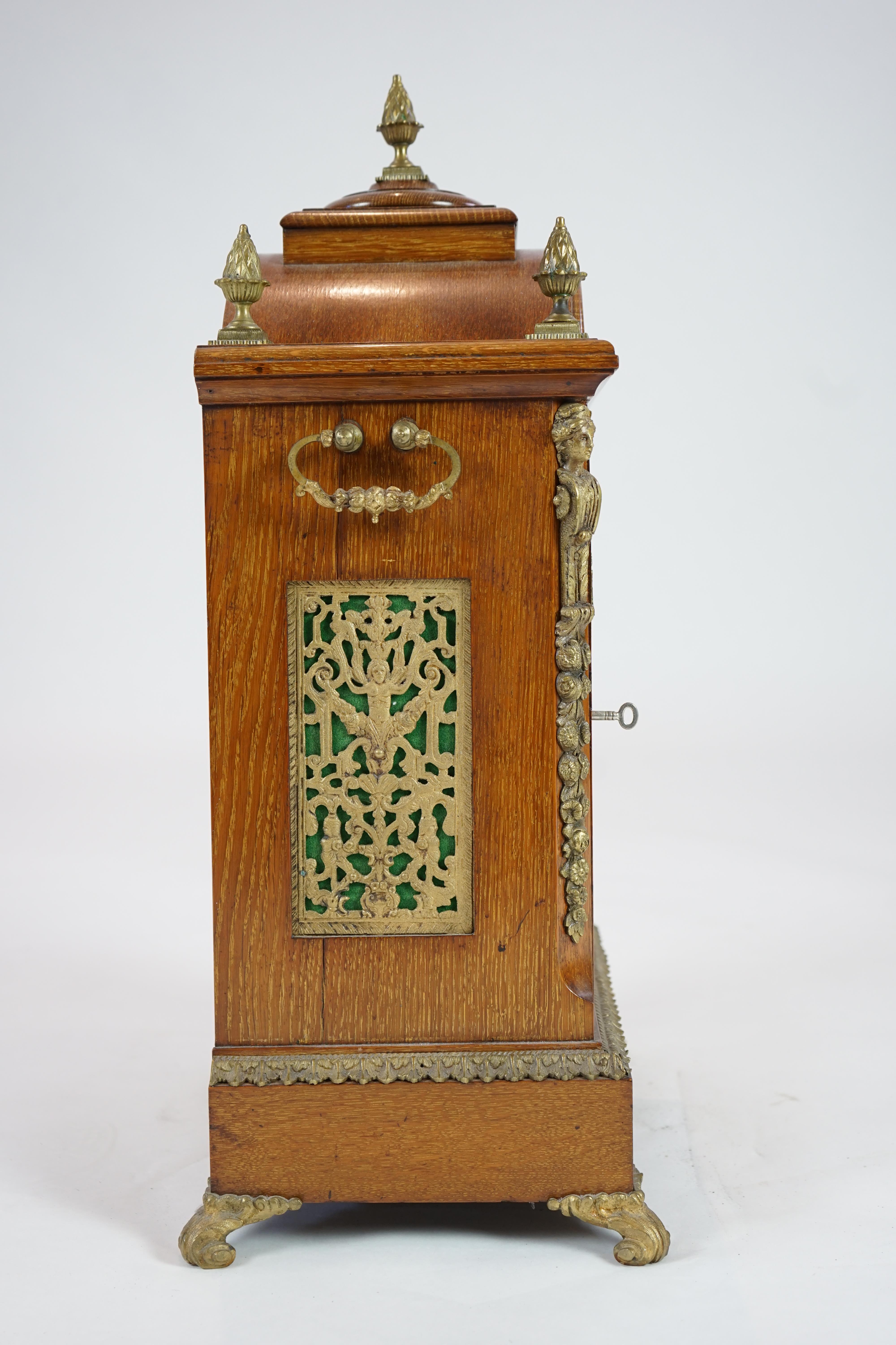 A late Victorian ormolu mounted golden oak cased eight day chiming bracket clock and bracket